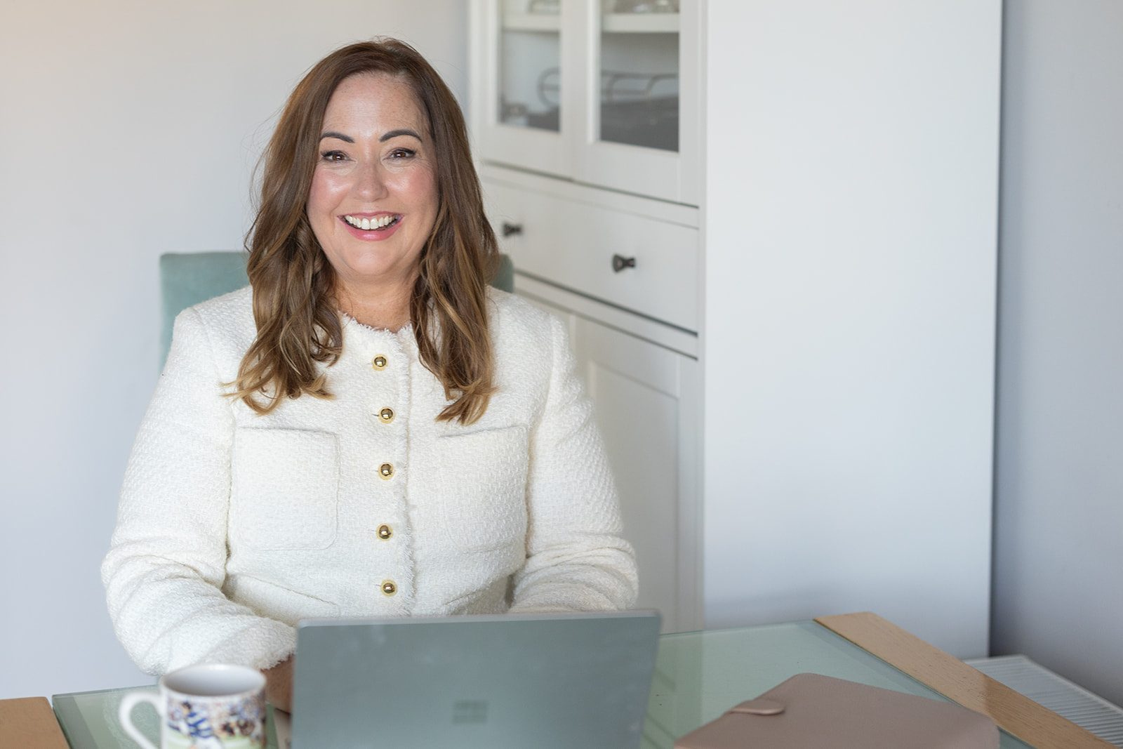 Helen Walsh smiling at her laptop